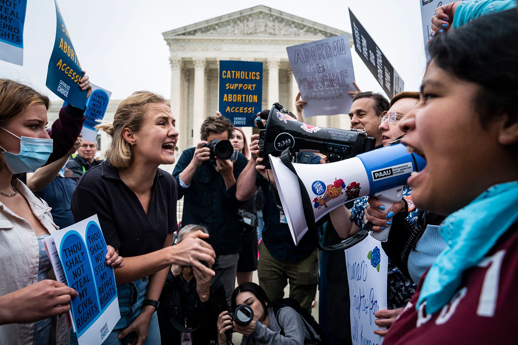 Abortion rights advocates and anti-abortions advocates face each other yelling in front of the U.S. Supreme Court.