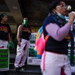 Abortion rights advocates hold signs that read 