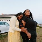 Ashley Manning is held by her daughter Rhiley after Ashley returns home from work. Ashley is wearing her work uniform.