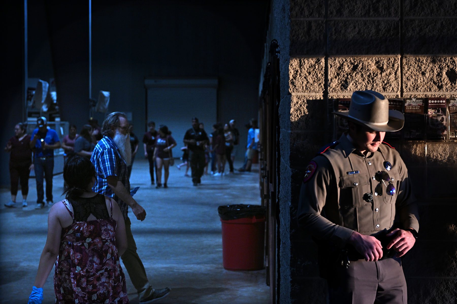 A police officer guards the door of the Uvalde County Fairplex.