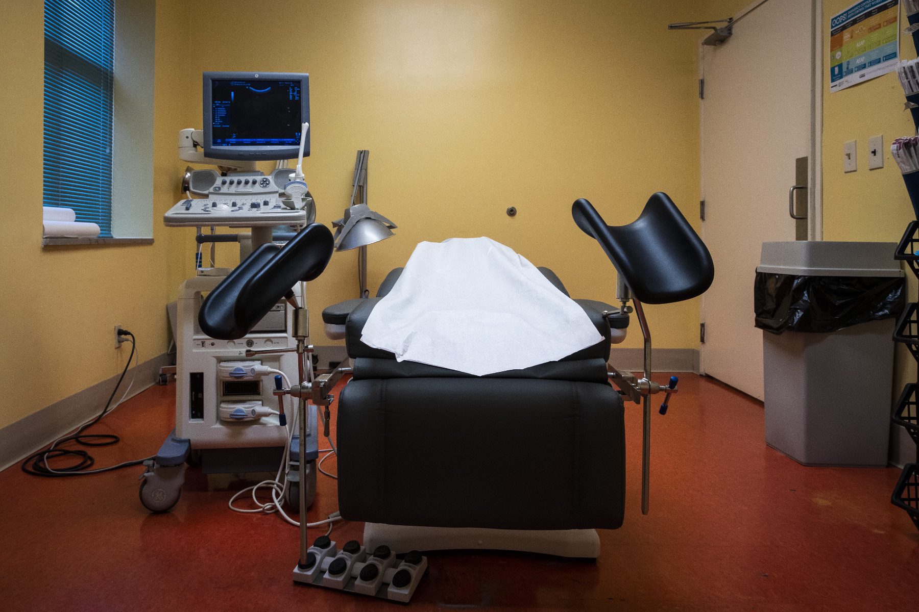 A procedural table set up in a medical room.