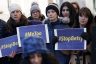 Activists hold signs during a news conference. The signs read "#StopBetsy" and "#MeToo"