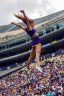 An LSU Tigers cheerleader is seen mid-air during a performance.