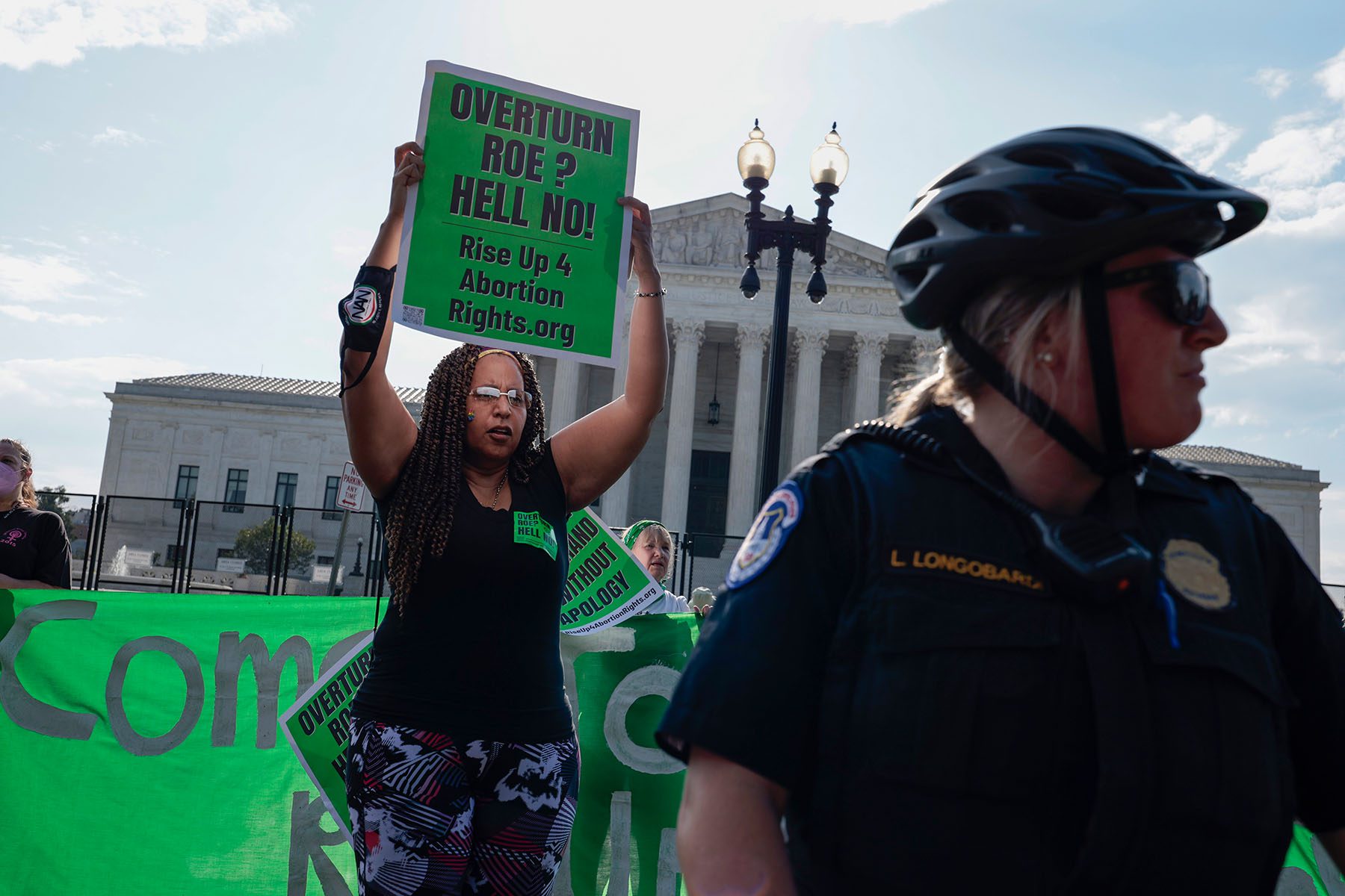 Capitol Police Officers stand in front of abortion rights activists as they demonstrate in front of the U.S. Supreme Court.