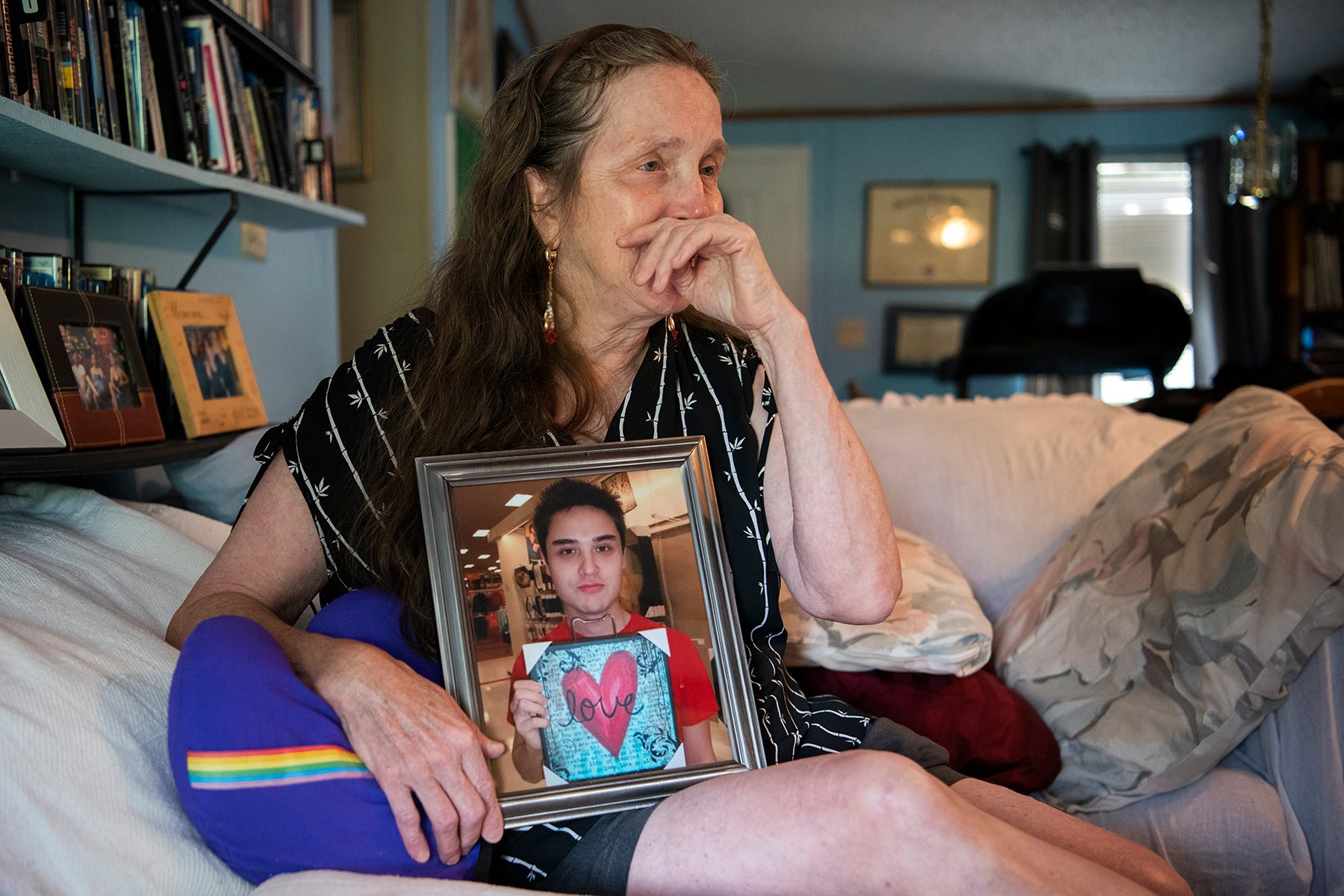 Christine Leinonen becomes emotional when speaking about her son while holding a framed picture of him.