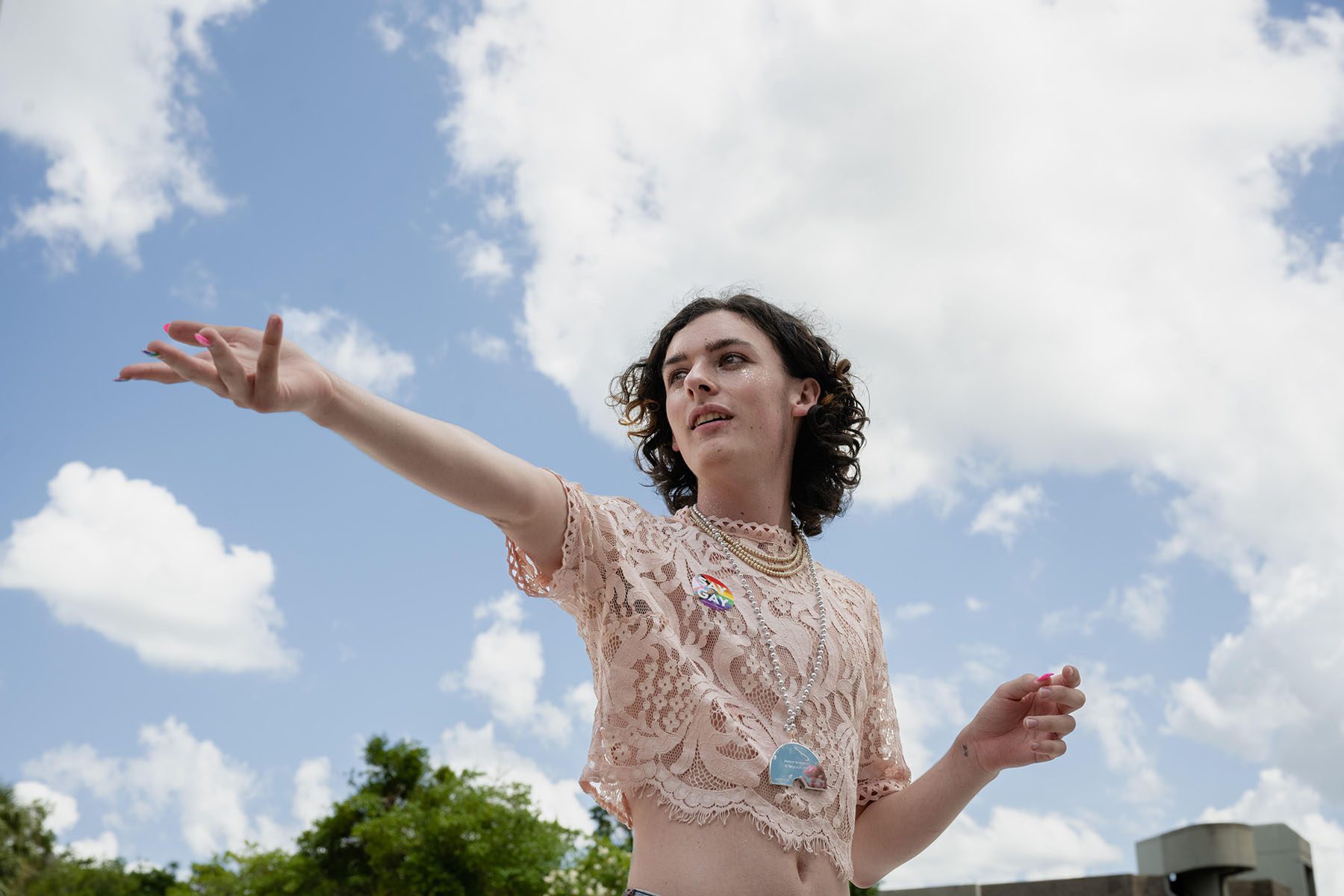 Portrait of Will Larkins, arms outstretched as they speak