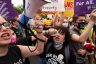 Abortion rights activists chant and hold signs during a rally.