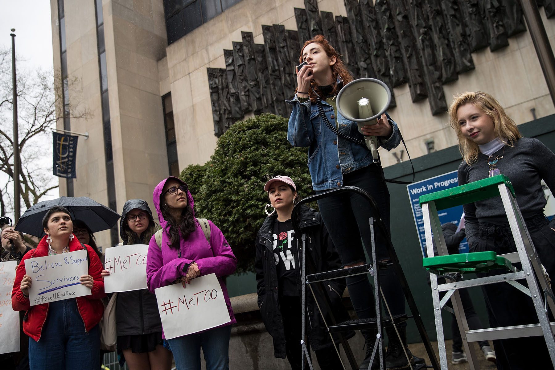 A group of student activists from Pace University hold a rally against sexual violence after walking out of their classes. They hold signs that read "#MeToo" and "Believe & Support Survivors"