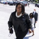 Rep. Cori Bush is walking up a set of stairs at the U.S. Capitol.