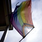 A pride flag is displayed outside a home