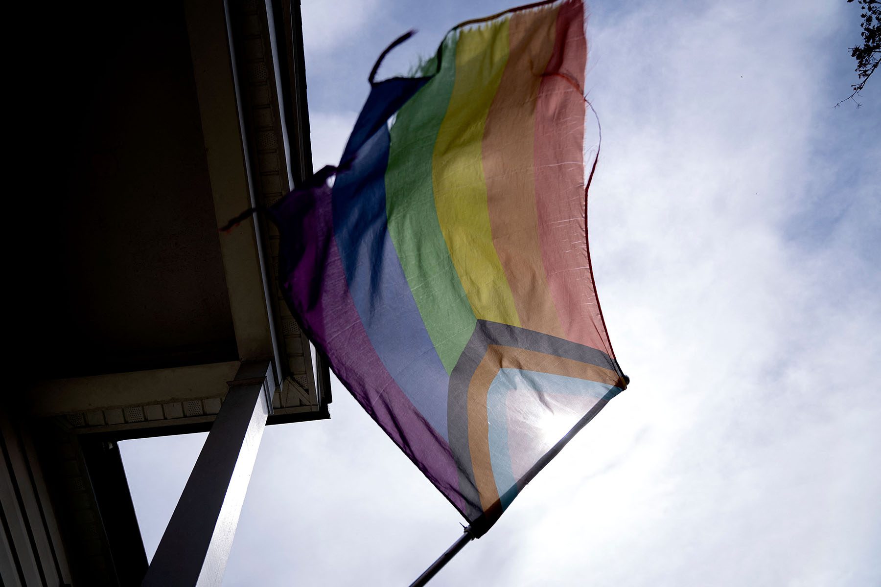 A pride flag is displayed outside a home