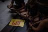 protesters sit around a yellow sign for abortion rights inside the indiana state capitol in indianapolis