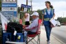 Cathy Nix is seen walking and holding a clipboard outside Planned Parenthood. A couple other anti-abortion protesters sit near the clinic.