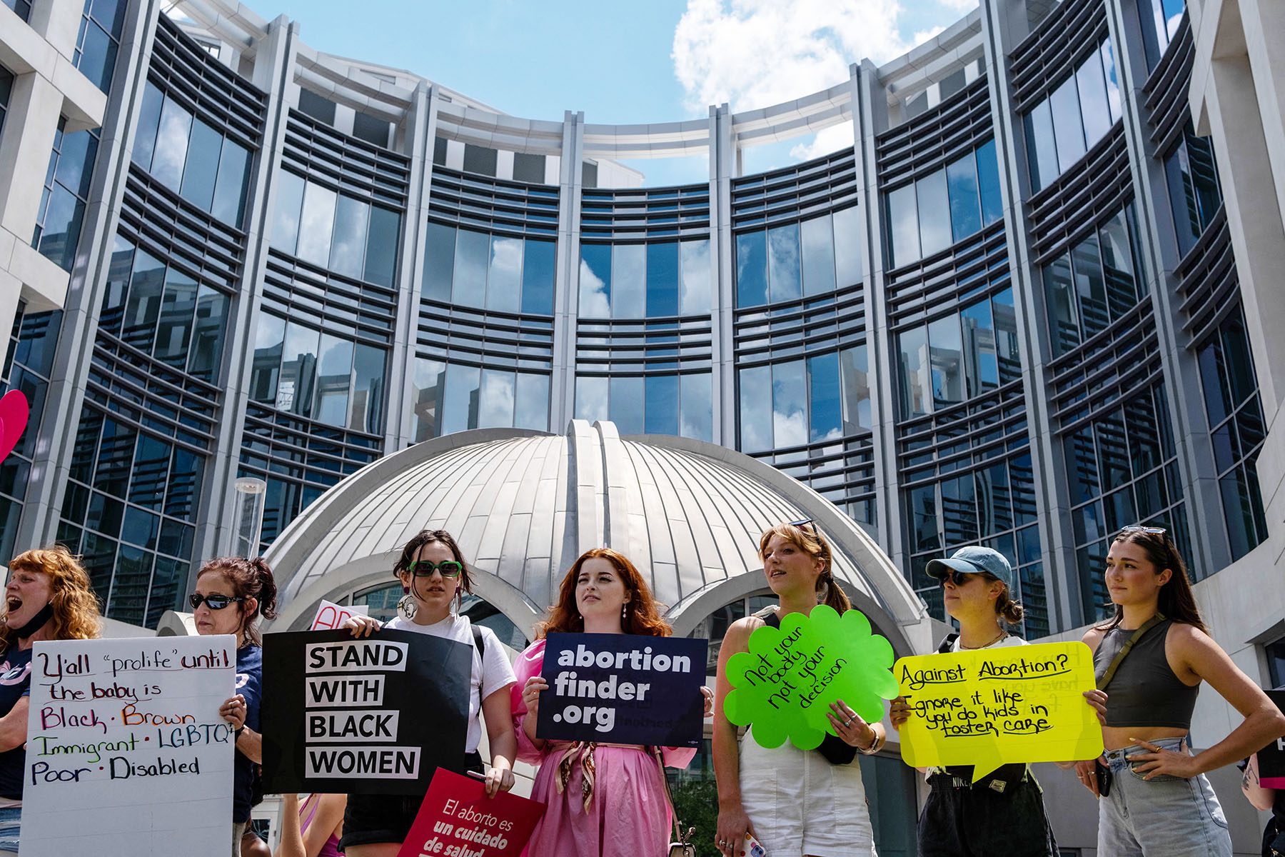 Activists gather near the Tennessee State Capital building. Signs read "Stand with Black women, "Against abortion? Ignore it like you do kids in foster care," "Y'all pro-life until the baby is black, brown, immigrant, LGBTQ, poor, disabled" and "not your body, not your decision"