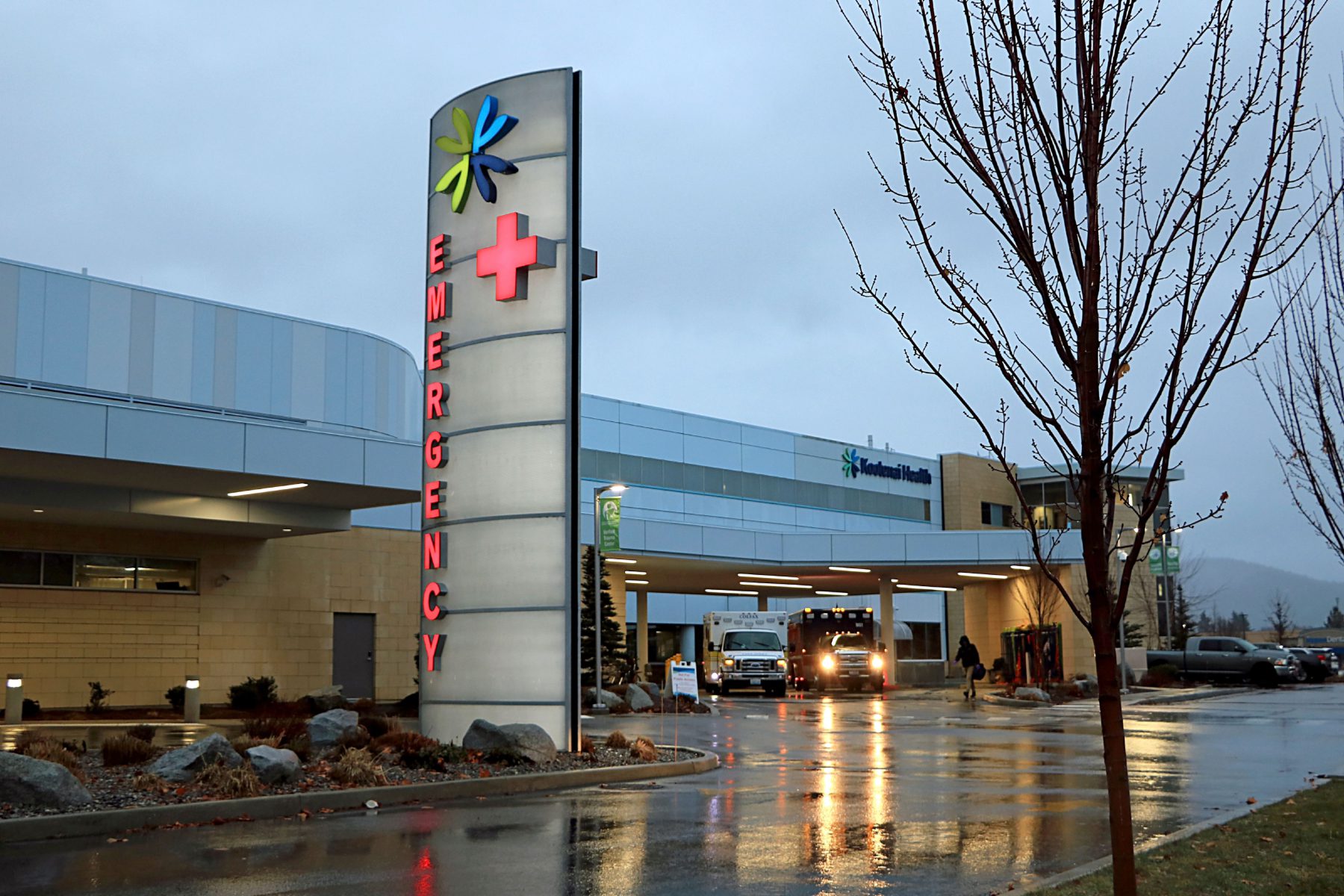 Emergency entrance at urban hospital at dusk with lighted sign, Kootenai Health hospital in Coeur d'Alene Idaho