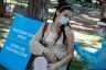 A Medical Reserve Corps volunteer administers a monkeypox vaccination to a Los Angeles resident in a park.