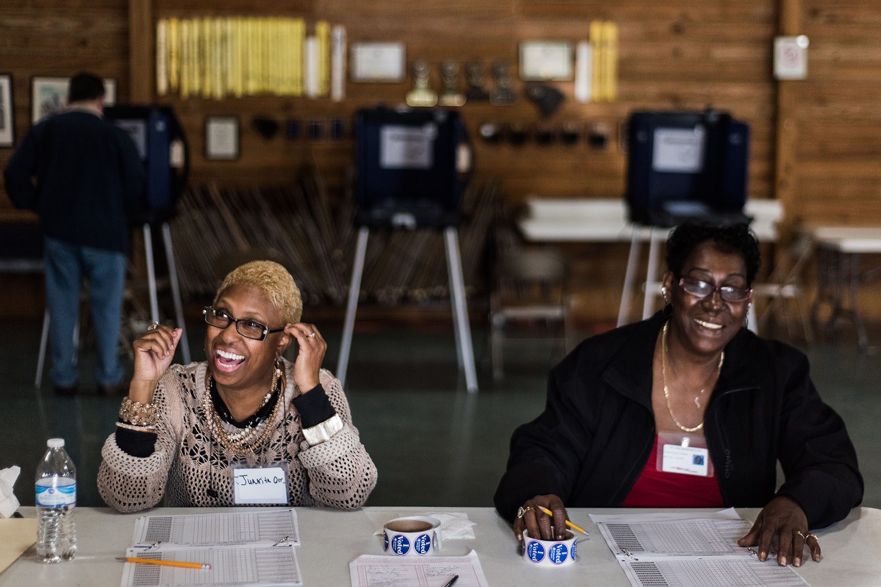 Two poll workers share a laugh with voters during the 2016 primaries in South Carolina.