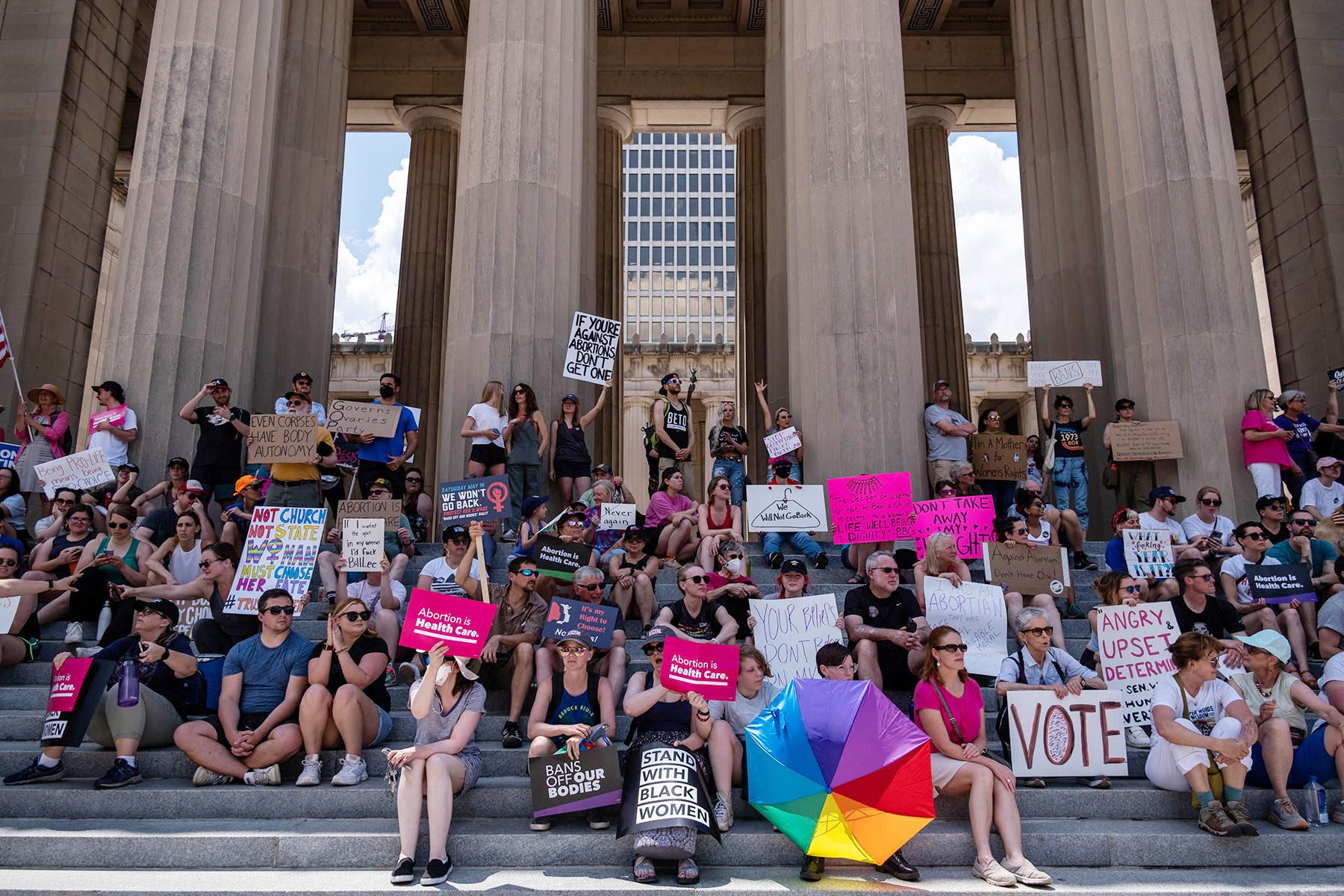 Abortion rights demonstrators sit on the steps of the Tennessee State Capitol while protesting.