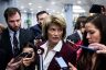 Sen. Lisa Murkowsk is surrounded by members of the press on Capitol Hill.