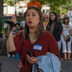 Yuh-Line Niou speaks into a microphone during a protest.