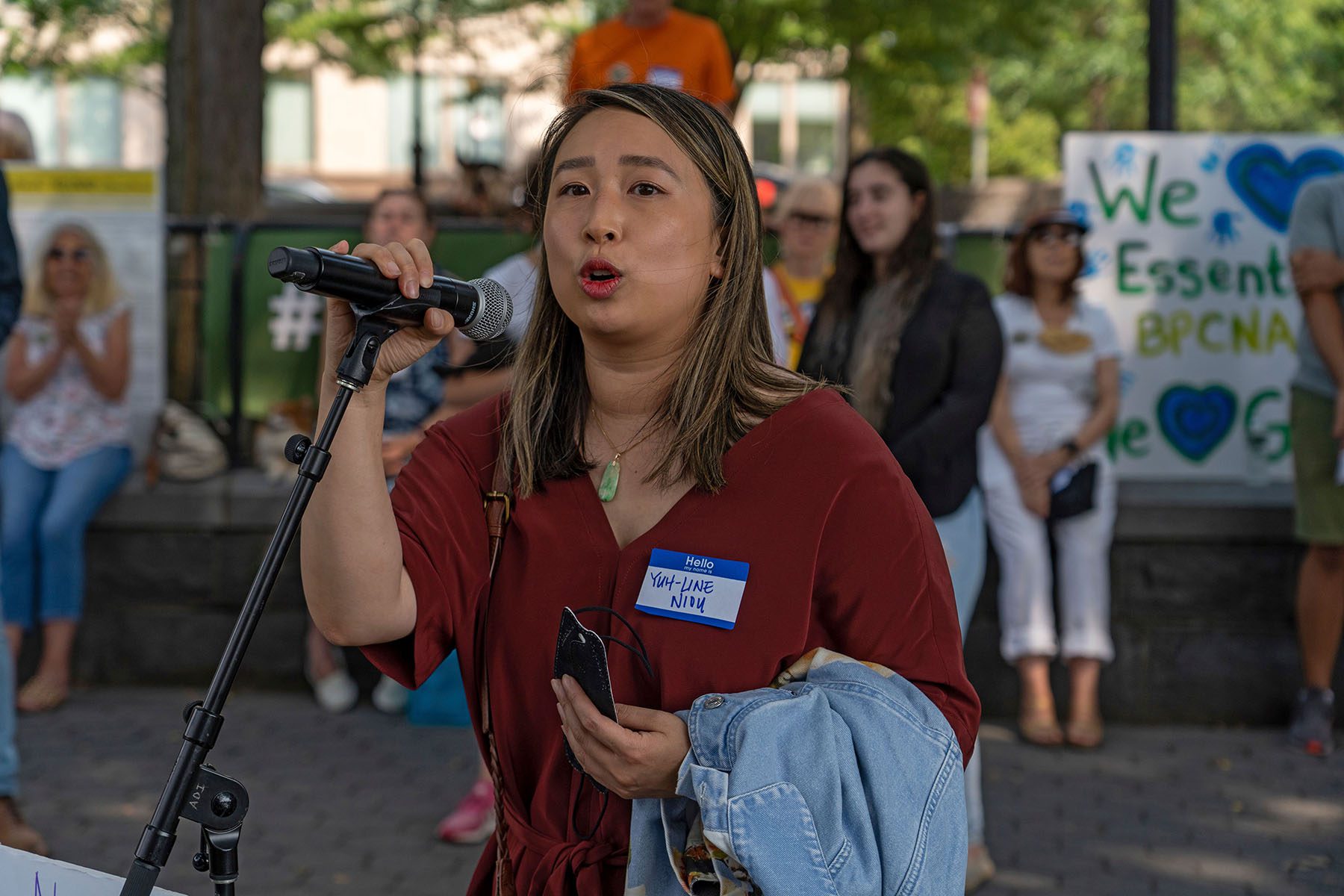 Yuh-Line Niou speaks into a microphone during a protest.