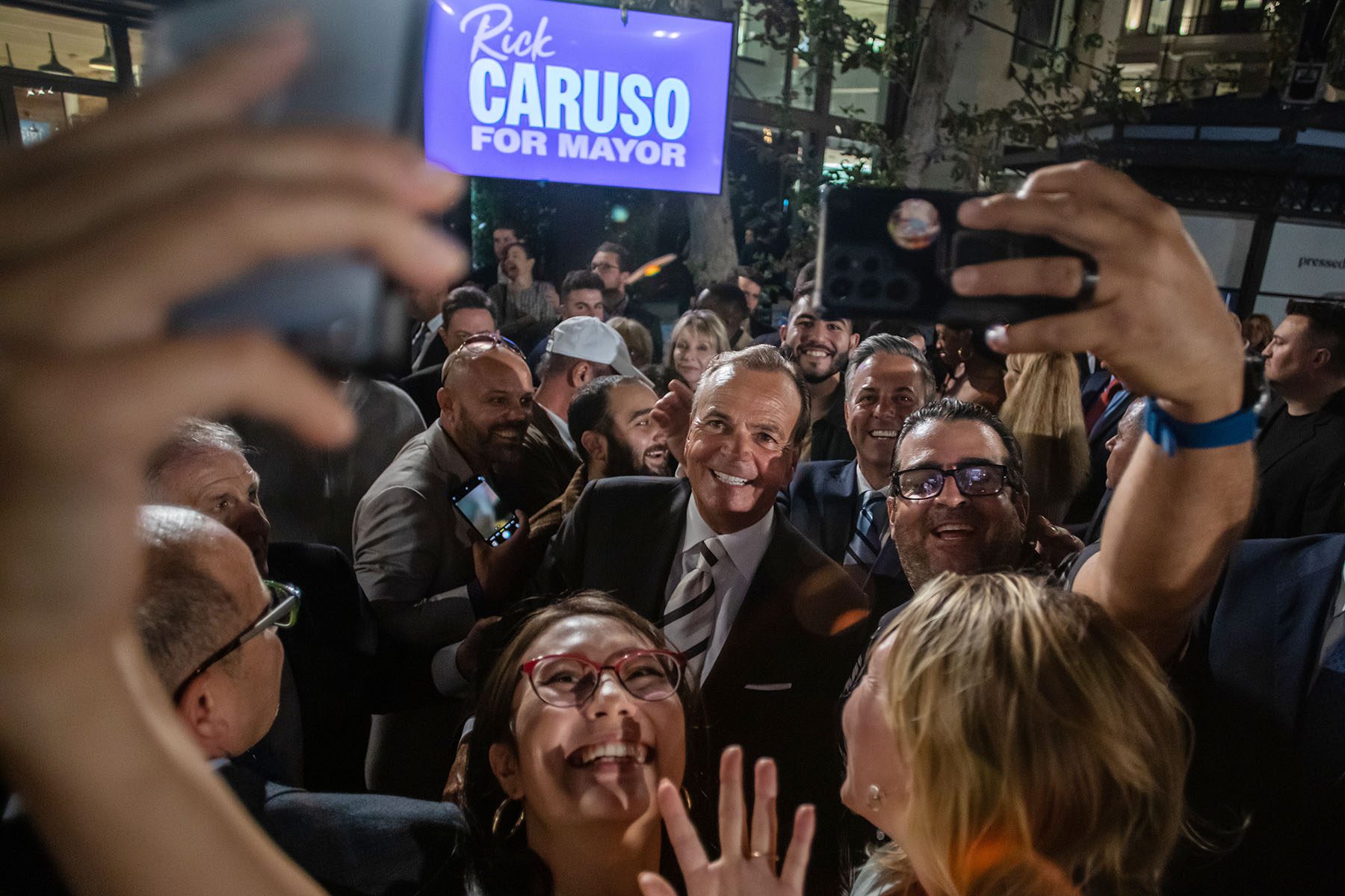Rick Caruso poses for selfies with supporters