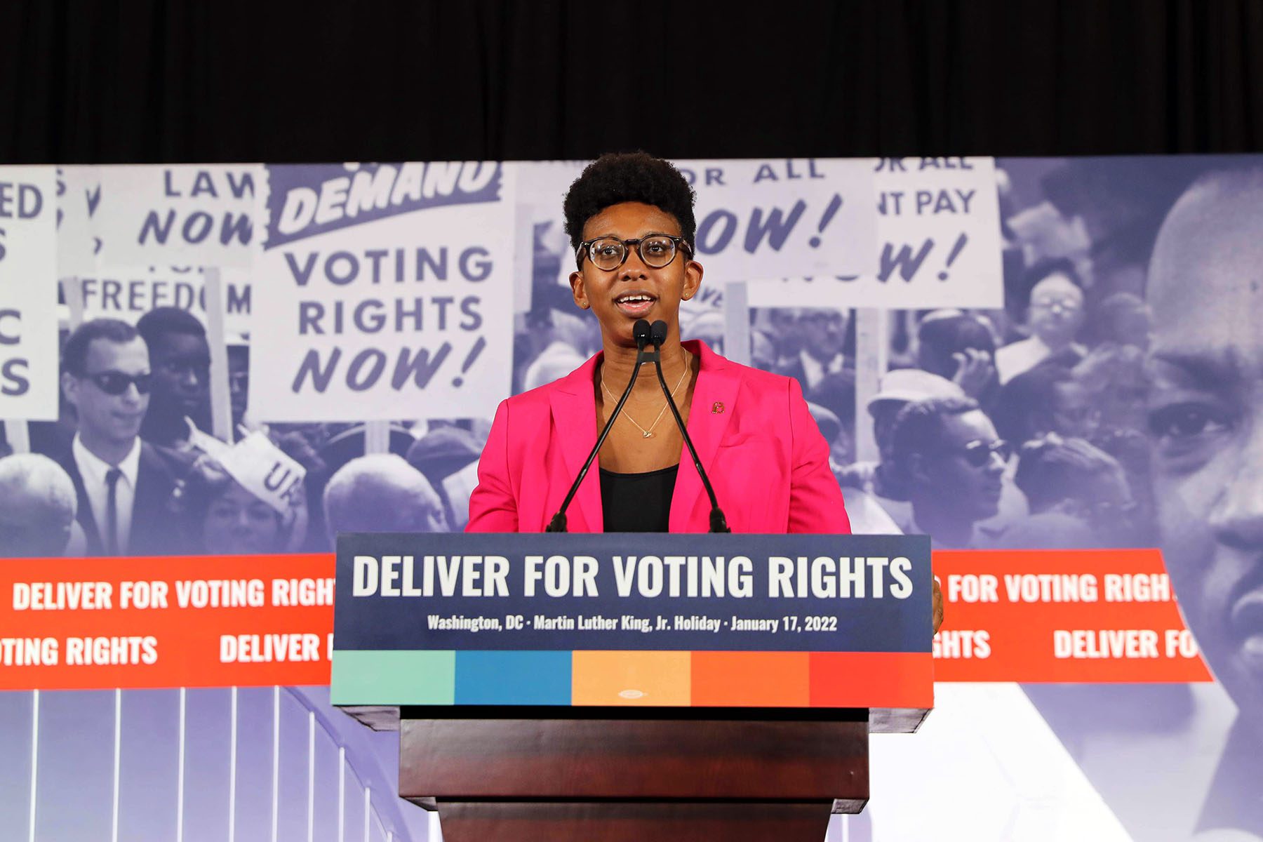 Kelley Robinson speaks at a podium during a press conference following the Peace Walk in celebration of Martin Luther King Jr. Day.