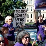 Abortion rights demonstrators gather outside the Michigan State Capitol during a 