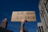 An abortion rights demonstrator raises a sign that reads 