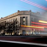 A vehicle drives past the Department of Justice building in Washington, D.C.