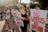 Abortion rights protesters hold signs that read 