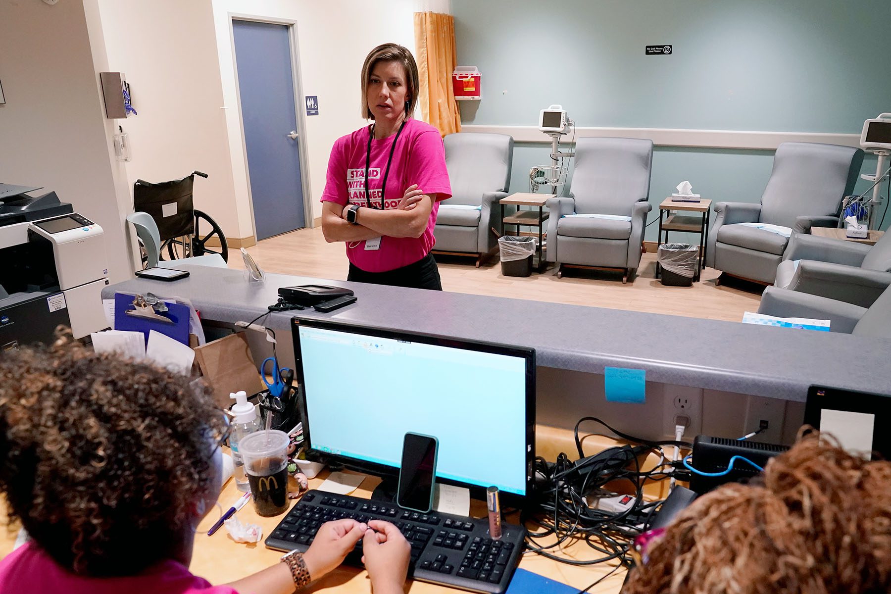 Dr. Jill Gibson speaks with staff in a Planned Parenthood waiting room.