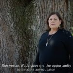 screenshot from South Carolina governor candidate Joe Cunningham’s newest ad in which a woman named Fran shares her abortion story. She is seen here standing near a tree and looking at the camera. The subtitles read 