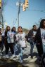 Students holding "go vote!" signs march to the polling place.