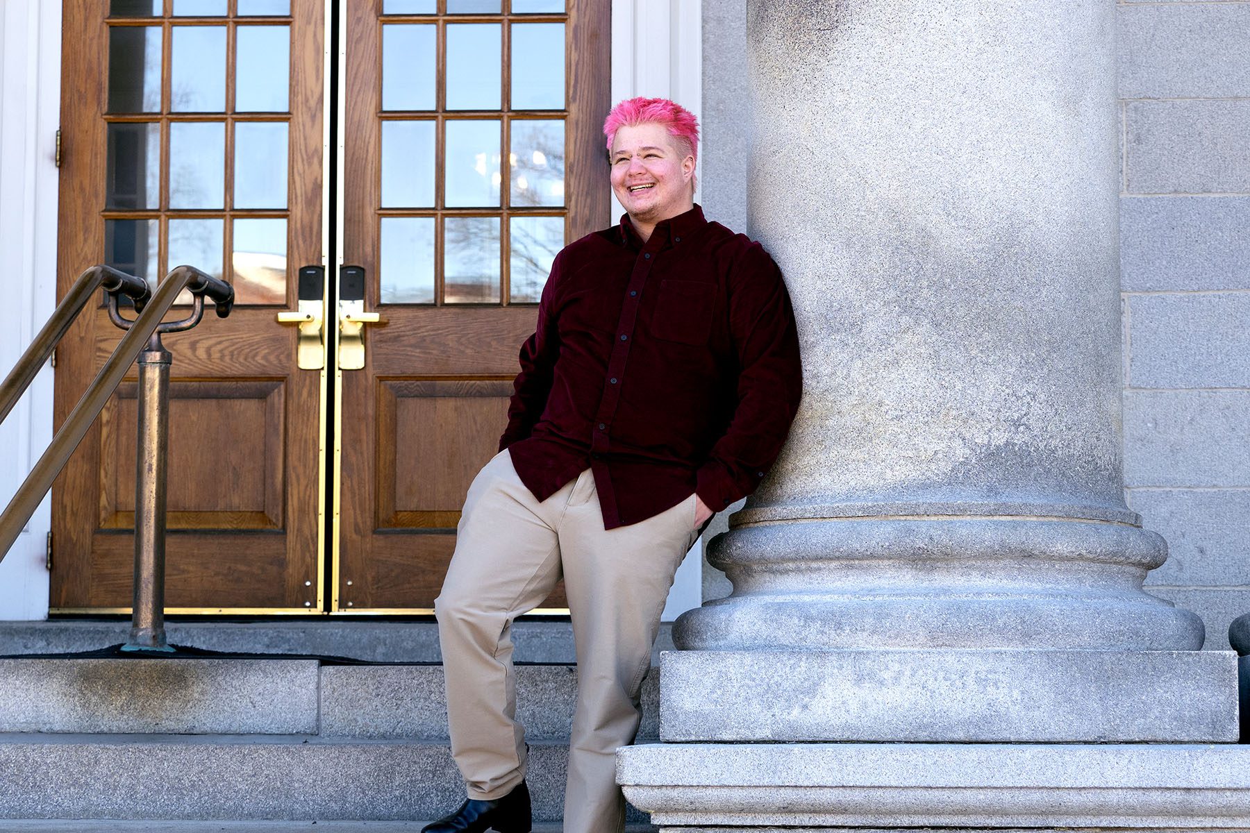 James Roesener poses for a portrait on the steps of the New Hampshire State House.