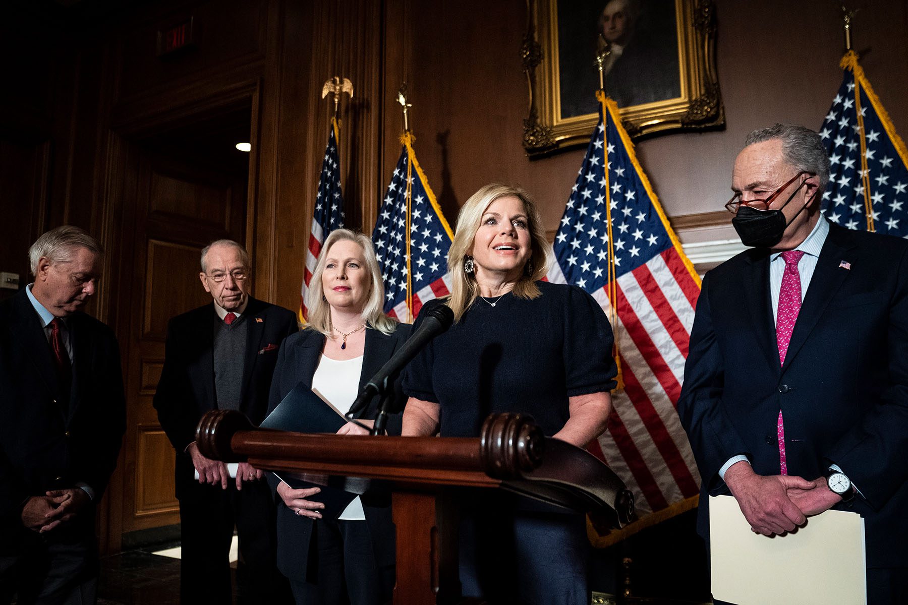 Gretchen Carlson speaks at a podium during a press conference with senators on Captiol Hill.