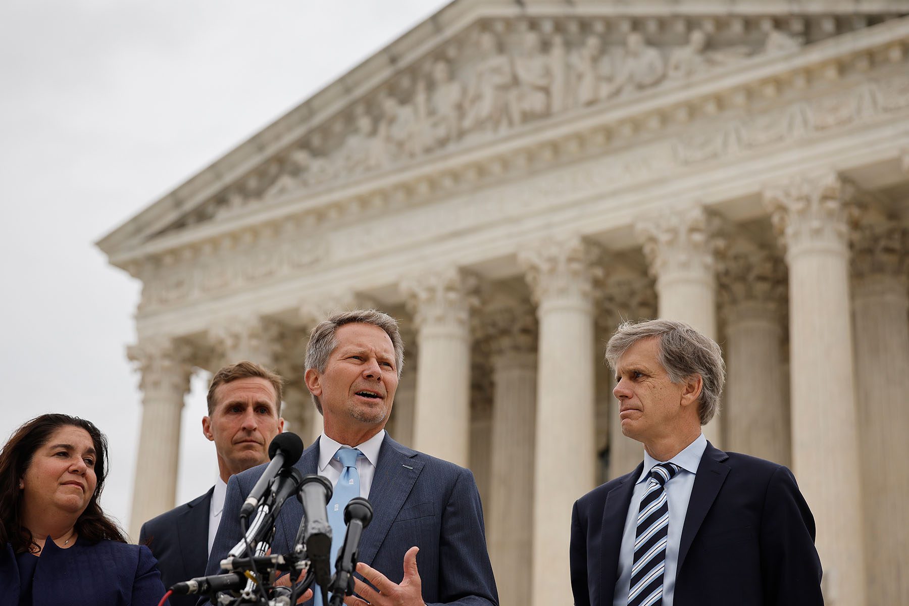 Kevin Guskiewicz talks with reporters outside the Supreme Court.