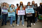 Proponents for affirmative action in higher education hold signs that read 