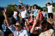 Attendees hold up two fingers during a rally encouraging voters to vote yes on Amendment 2.