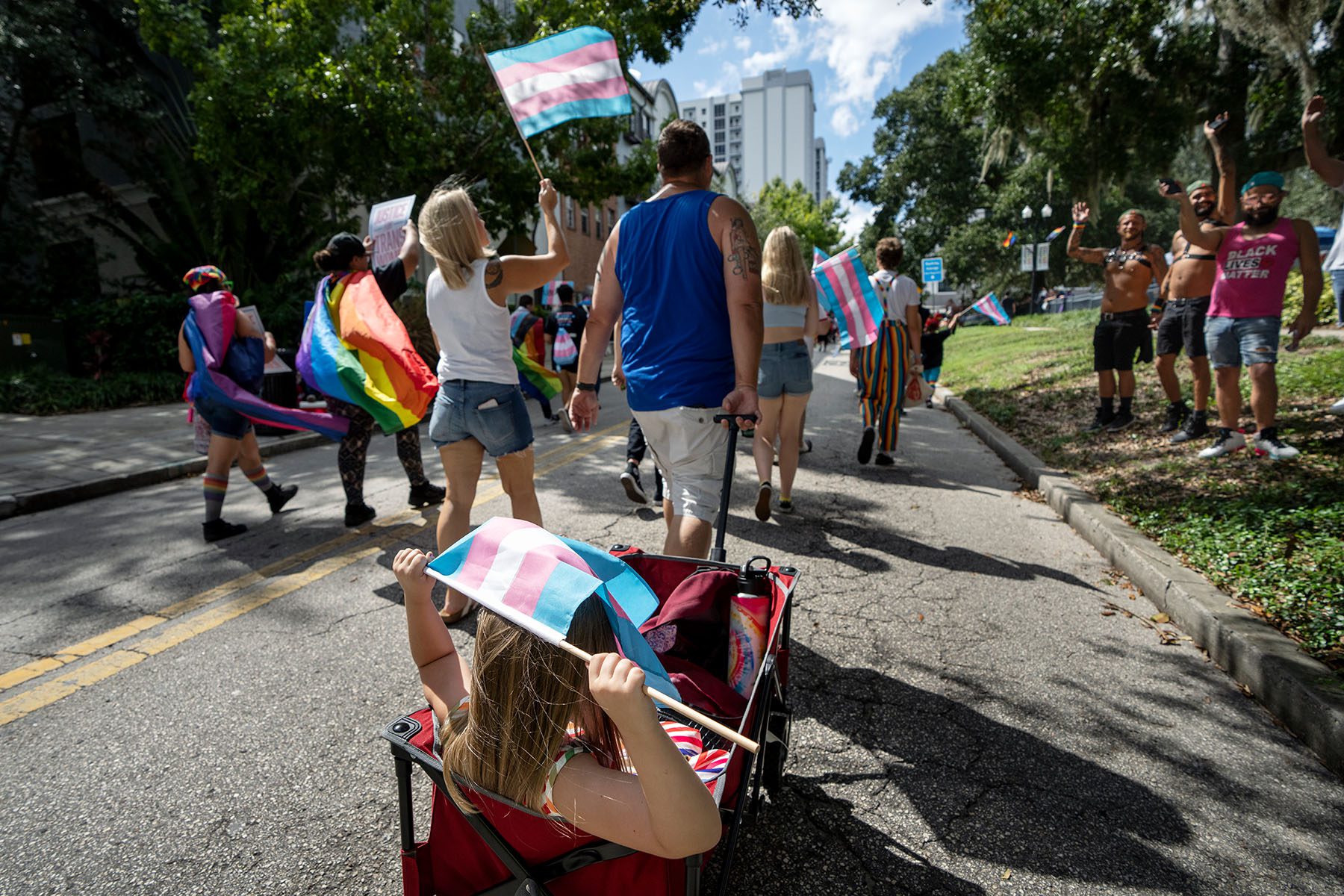 Participants wave flags at the National Trans Visibility March in Orlando, Florida.