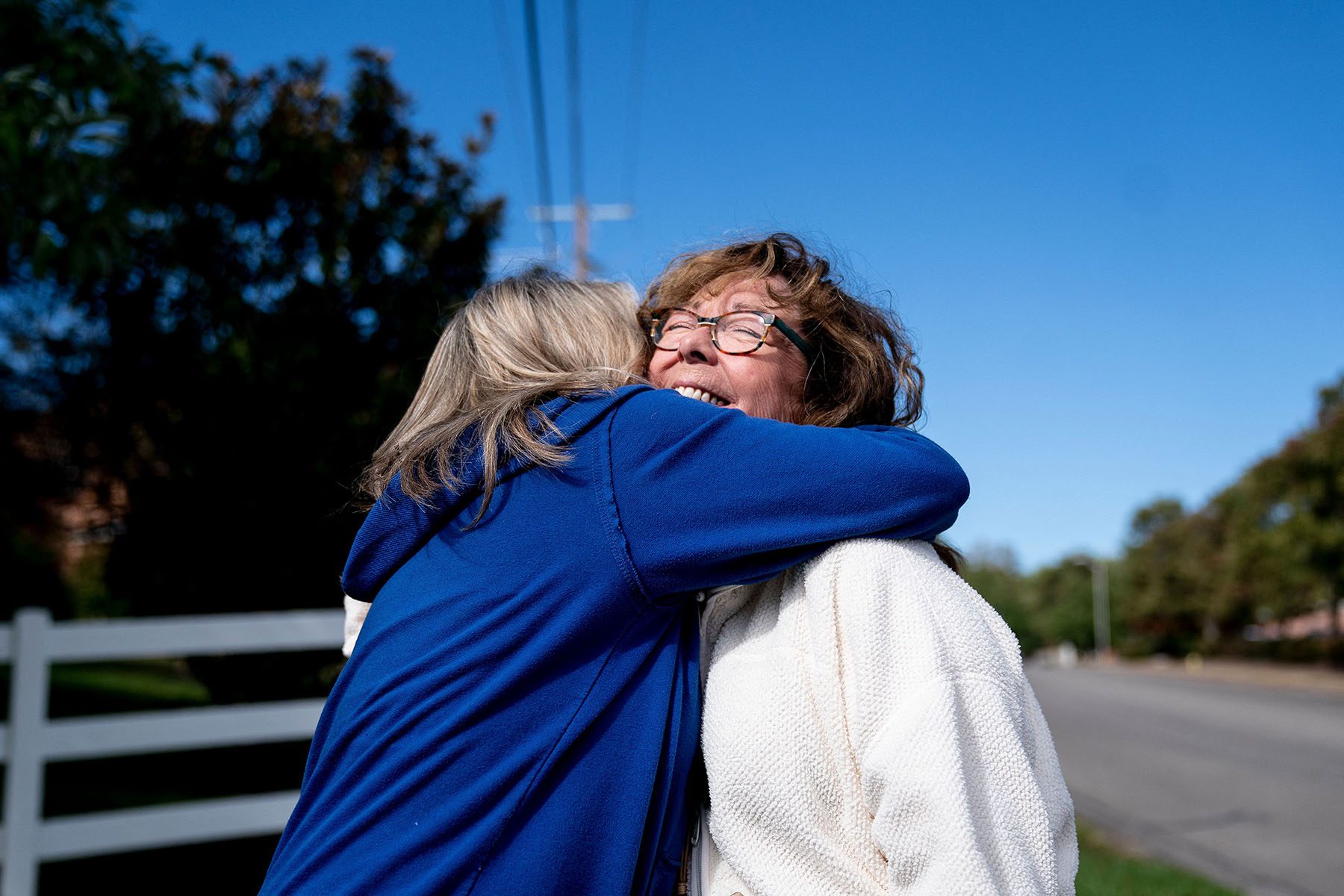 Two women volunteers hug each other as they canvass around Lexington, Kentucky.