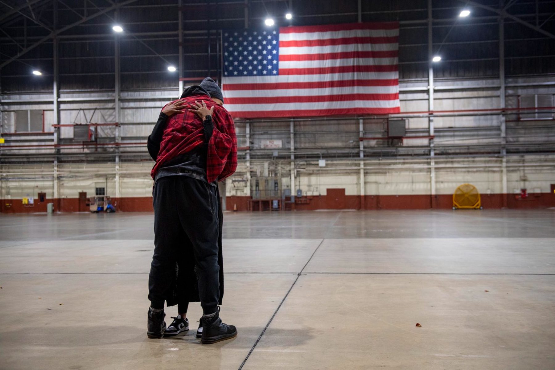 Brittney and Cherelle Griner share a hug in an airport hangar.