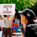 A woman supporting abortion rights reacts to an anti-abortion protest outside the South Carolina Statehouse.