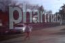 A pedestrian is reflected in the window of a CVS Pharmacy.