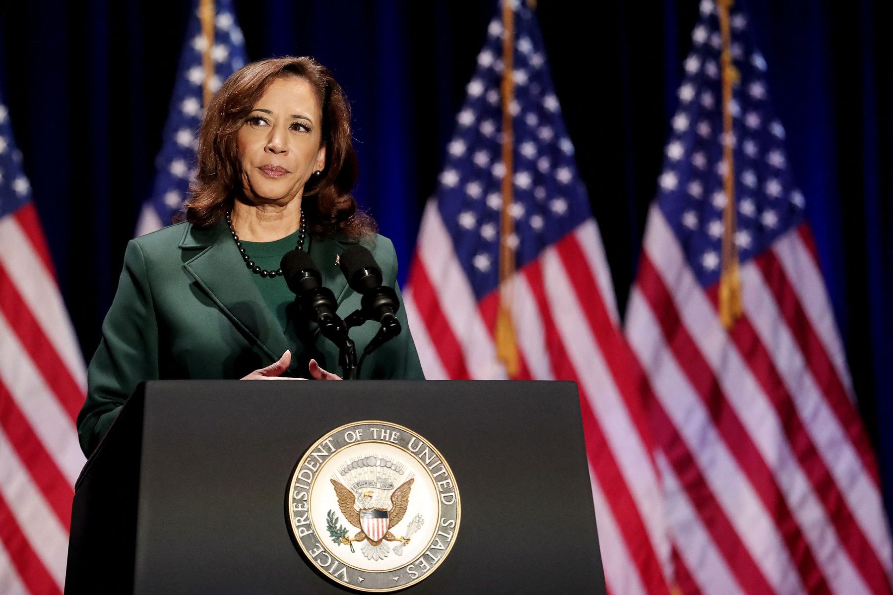 US Vice President Kamala Harris speaks at a podium.