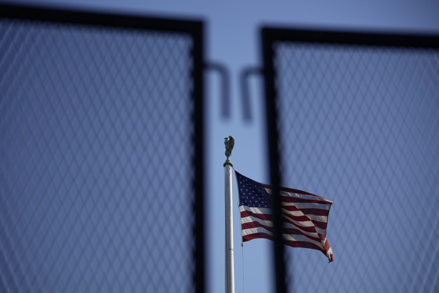 american flag as seen through a security fence at the Supreme Court in Washington DC