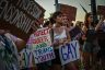 LGBTQ+ rights supporters protest against Florida Governor Ron DeSantis outside a 