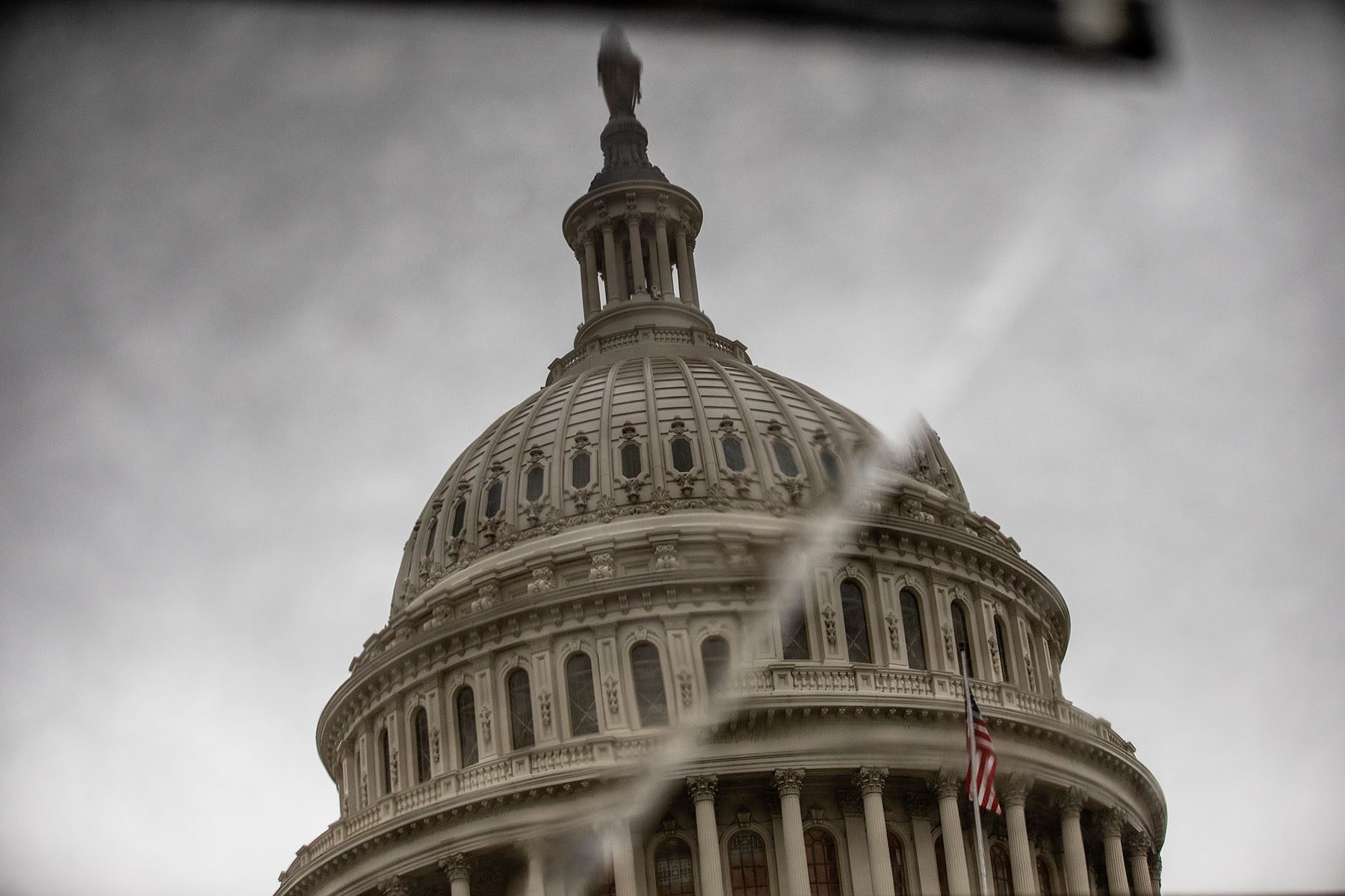 The dome of the U.S. Capitol is reflected on a broken piece of tile.