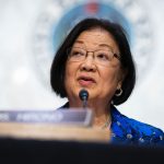 Sen. Mazie Hirono speaks into a microphone on Capitol Hill.