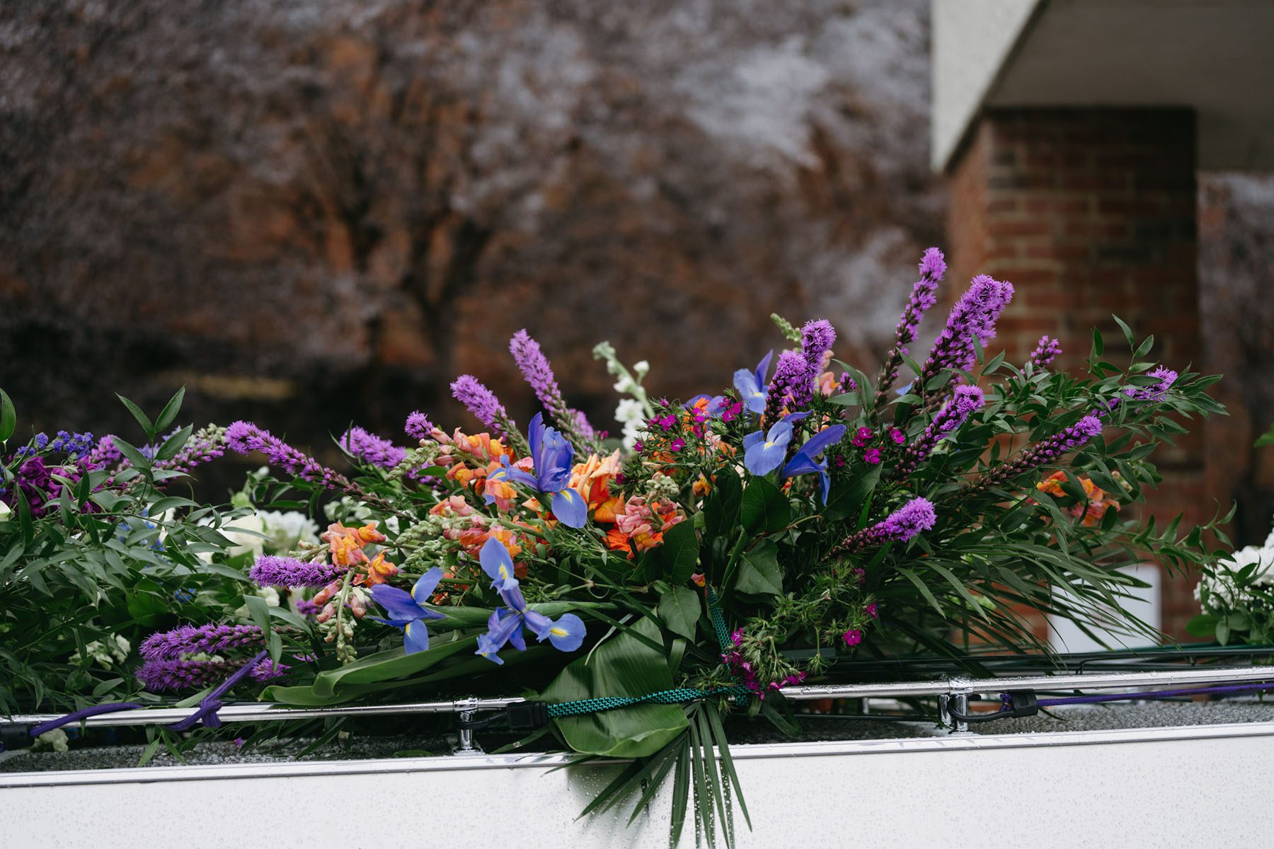 Flowers lay on the hearse leading Tyre Nichols' family's cars.